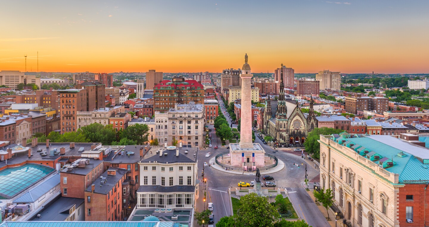 Technician sweeping a classic Baltimore rowhome chimney